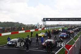 The cars stop on the grid after the race is red flagged on the formation lap due to heavy rain